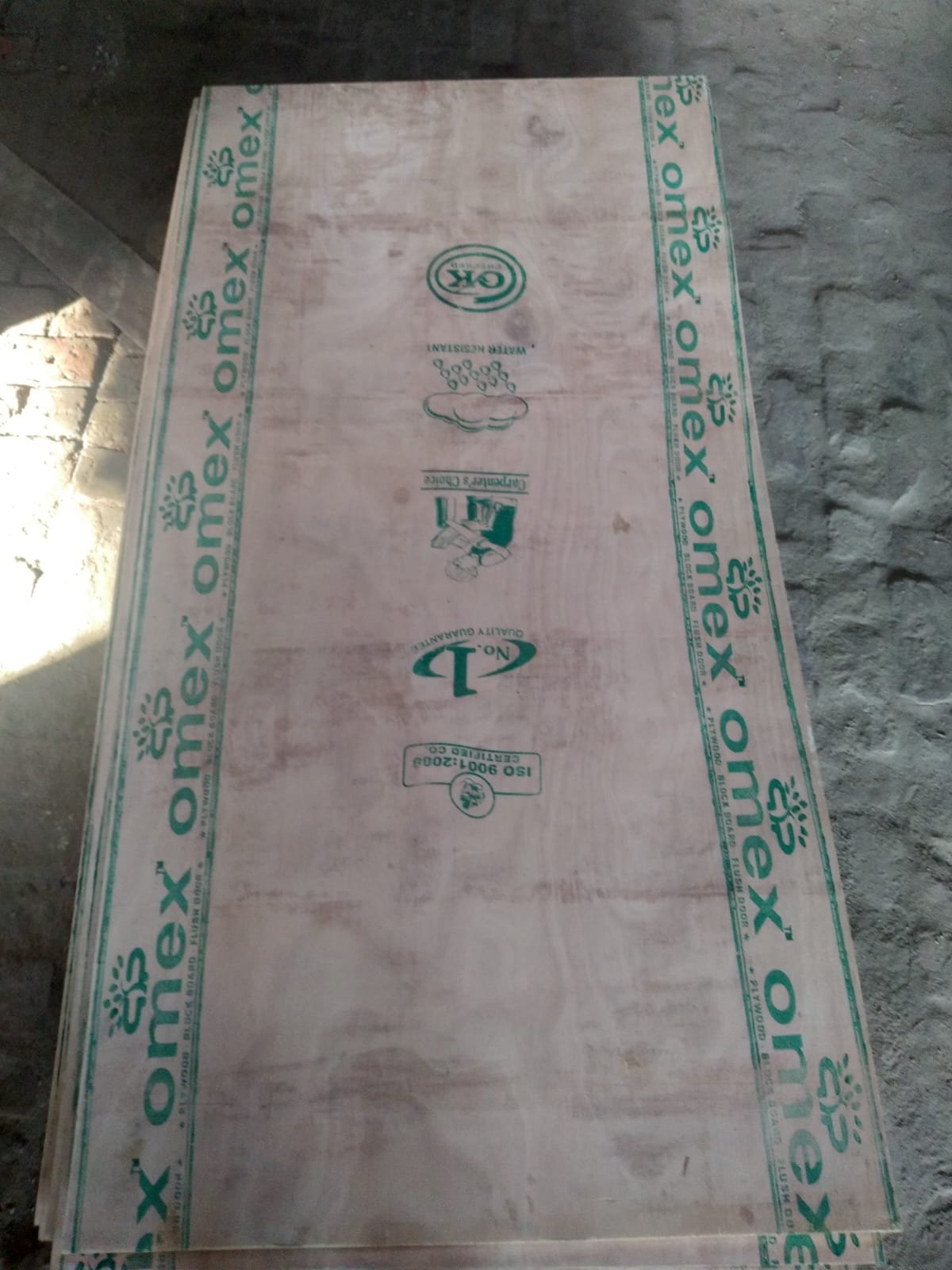 Client-supplied factory photograph of a sheet with Omex branding